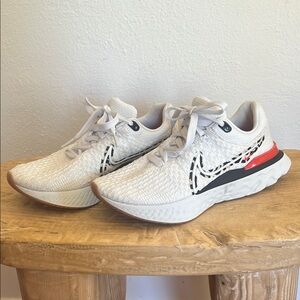 Nike Women’s White Knit Running Shoes with Black Swoosh and Red Heel Accent